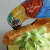 Parrot figurine and butterfly